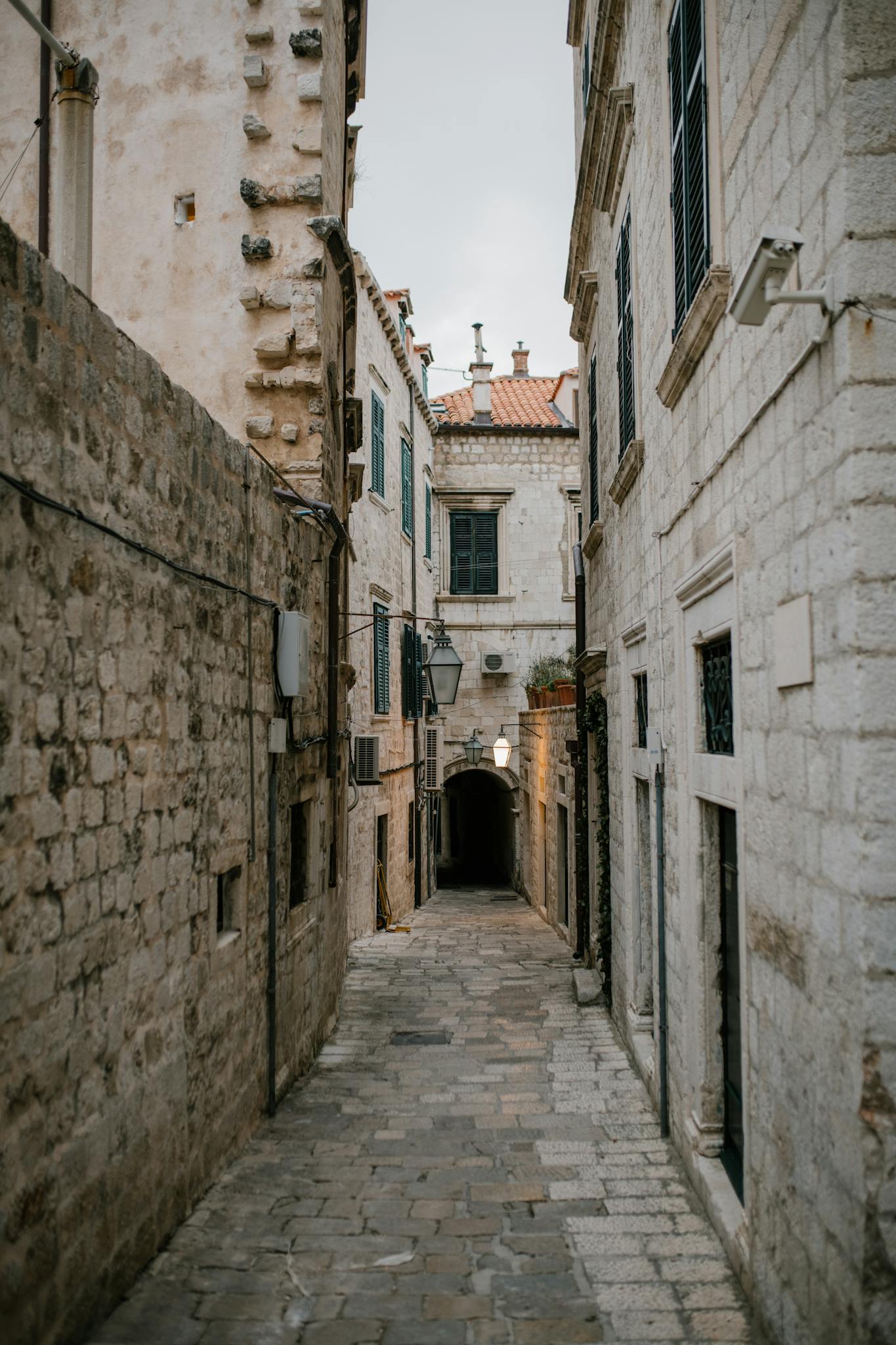 Narrow cobblestone street with old shabby brick buildings