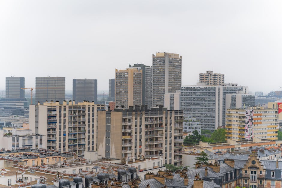 A view of a city with tall buildings and a cloudy sky