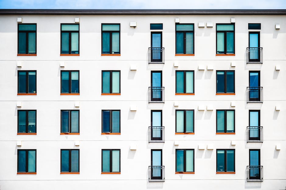 Facade of new white apartment building of simple minimalist style on clear day