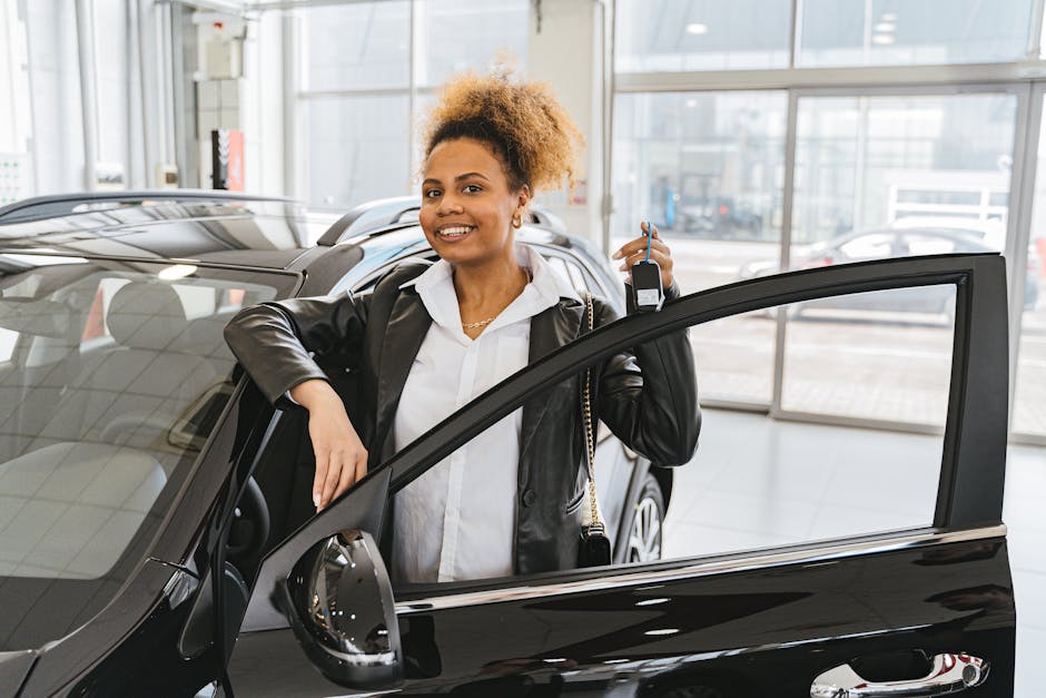 Woman in Black Blazer Standing Beside Black Car