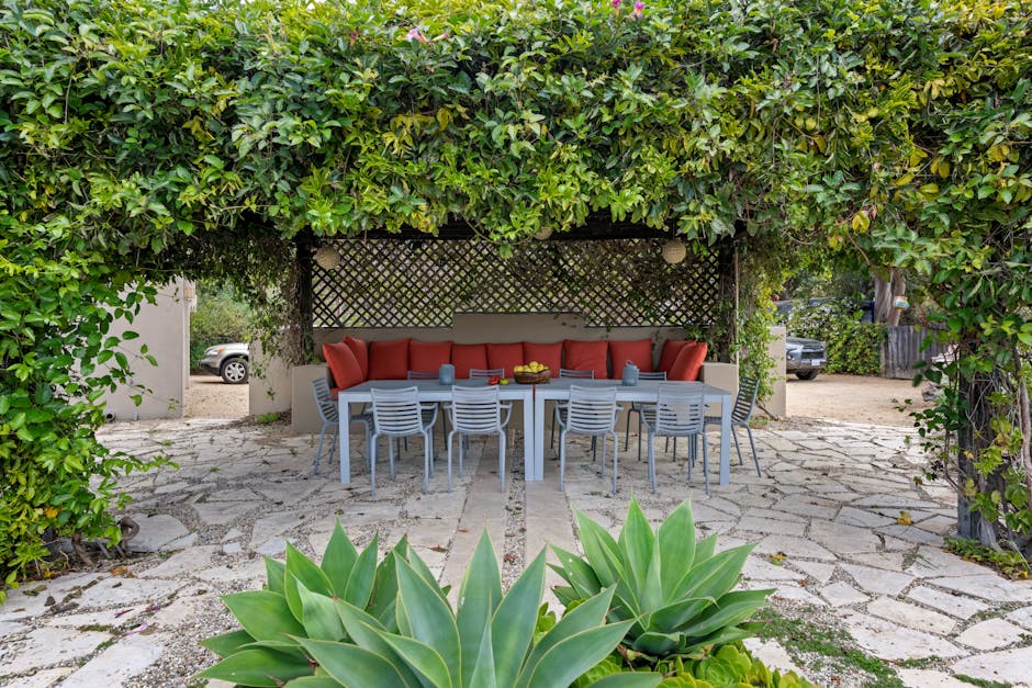 Sofa, Chairs and a Table on the Patio in the Garden