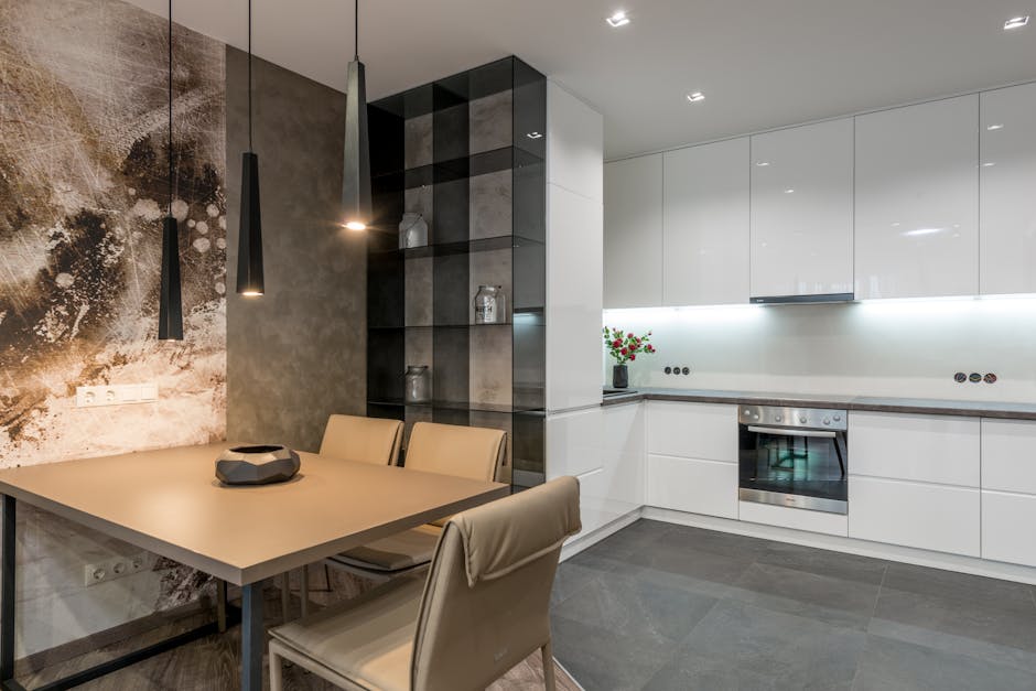 Wooden dining table with comfortable chairs placed in modern spacious kitchen with white cupboards and contemporary appliances