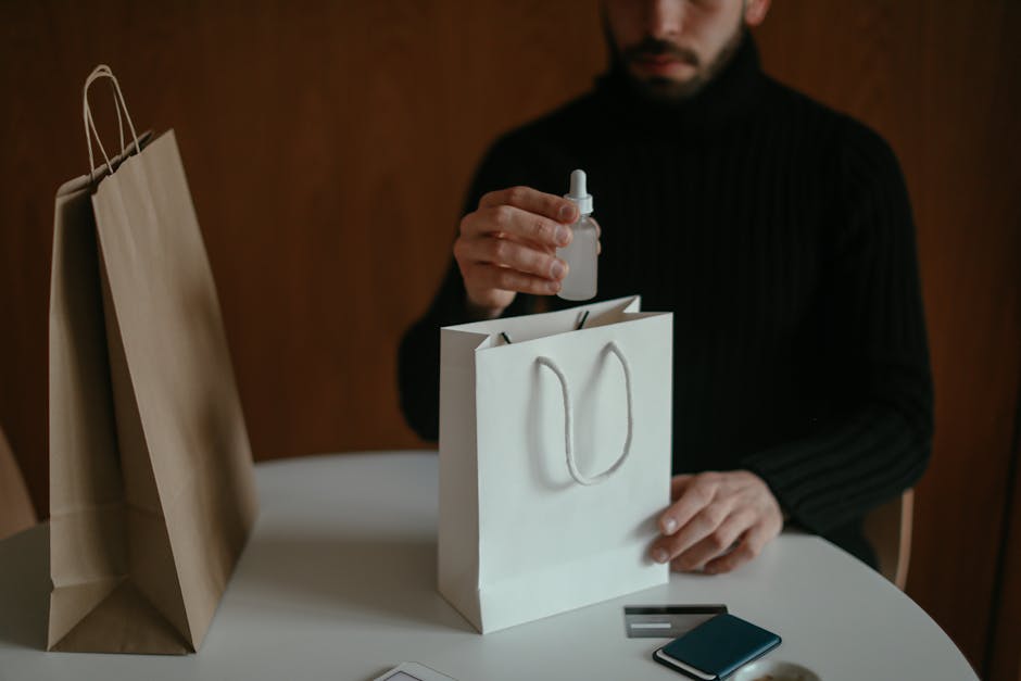 Focused man pulling out beauty product from shopping bag at table