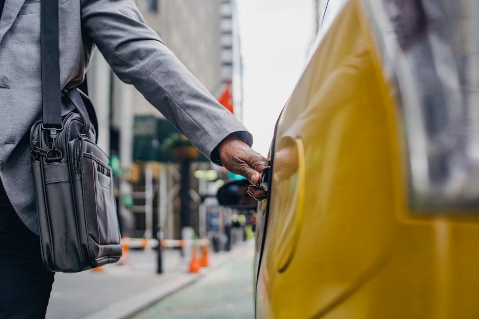 Black man touching door of taxi