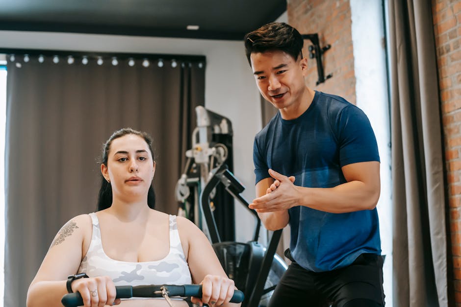 Supportive Personal Trainer Helping a Woman at the Gym