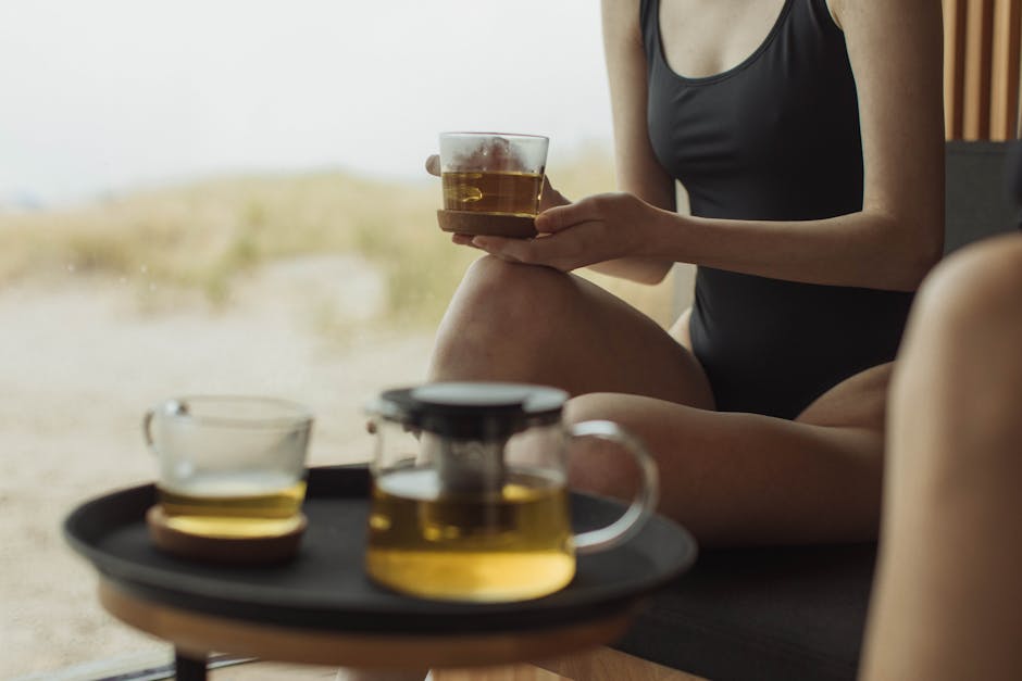 Woman in Black Tank Top Holding Clear Glass Mug