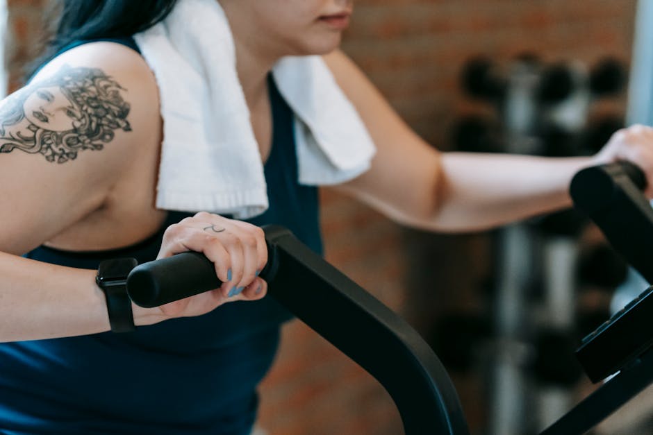 Young woman doing exercises on cycling machine