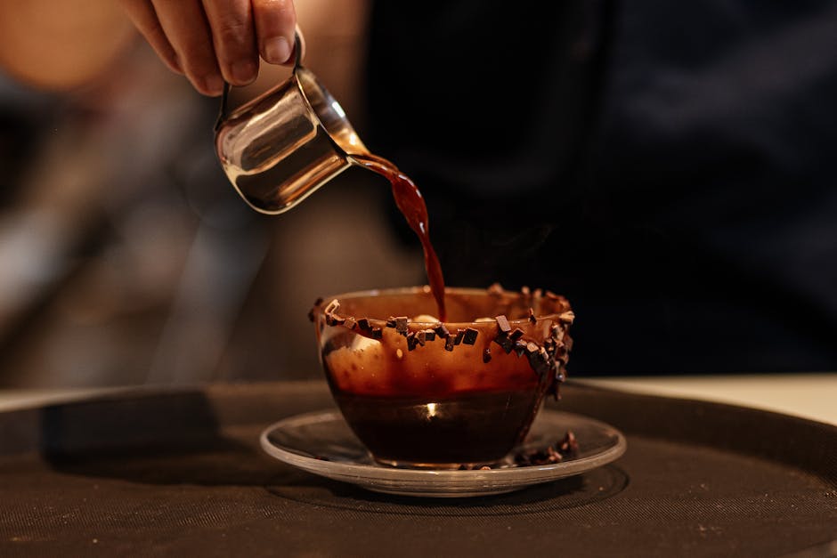 A person pouring coffee into a cup