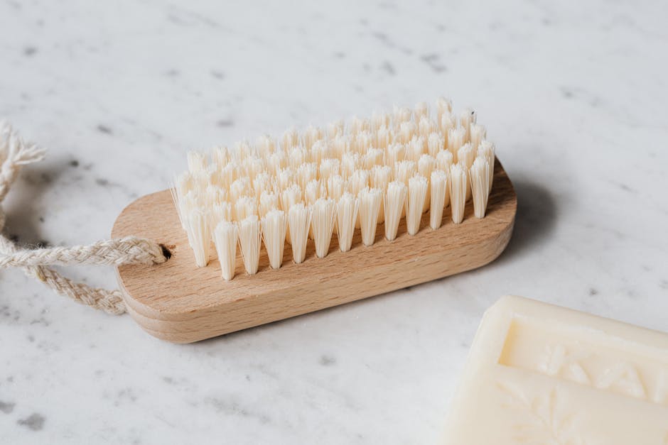 Cleaning brush and soap on marble table