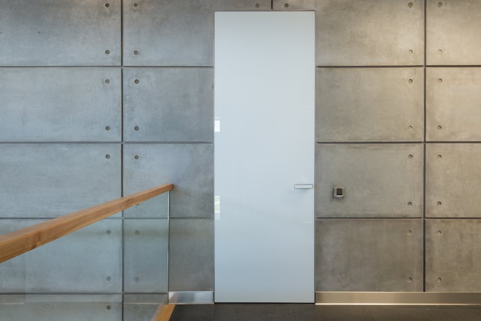 White interior door and gray stony tiled walls in hallway of contemporary loft style house