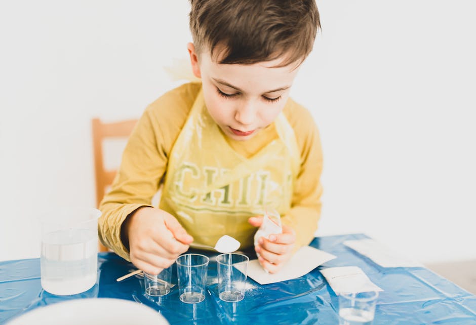 Crop boy with dry solution and glasses preparing for experiment