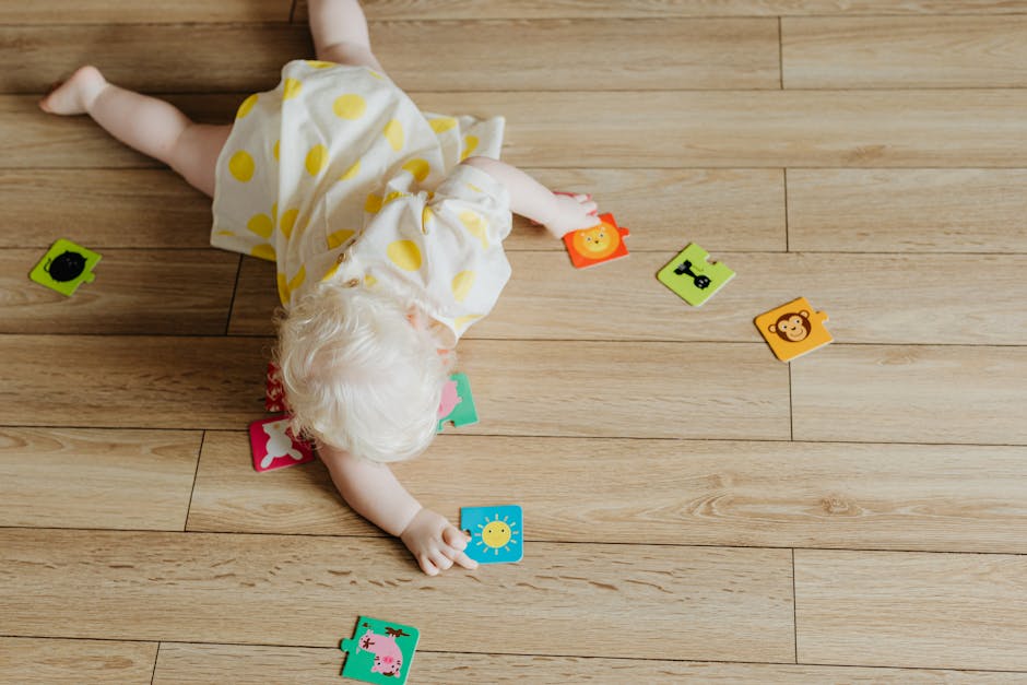 A Toddler Playing with Puzzle Pieces on the Floor