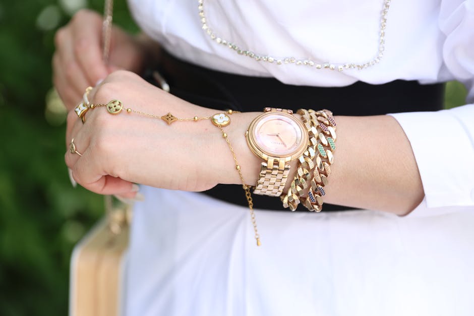 A woman wearing a white shirt and gold bracelet