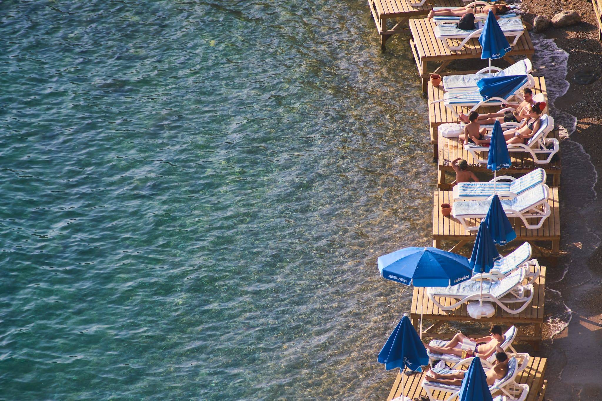 People Relaxing On The Beach