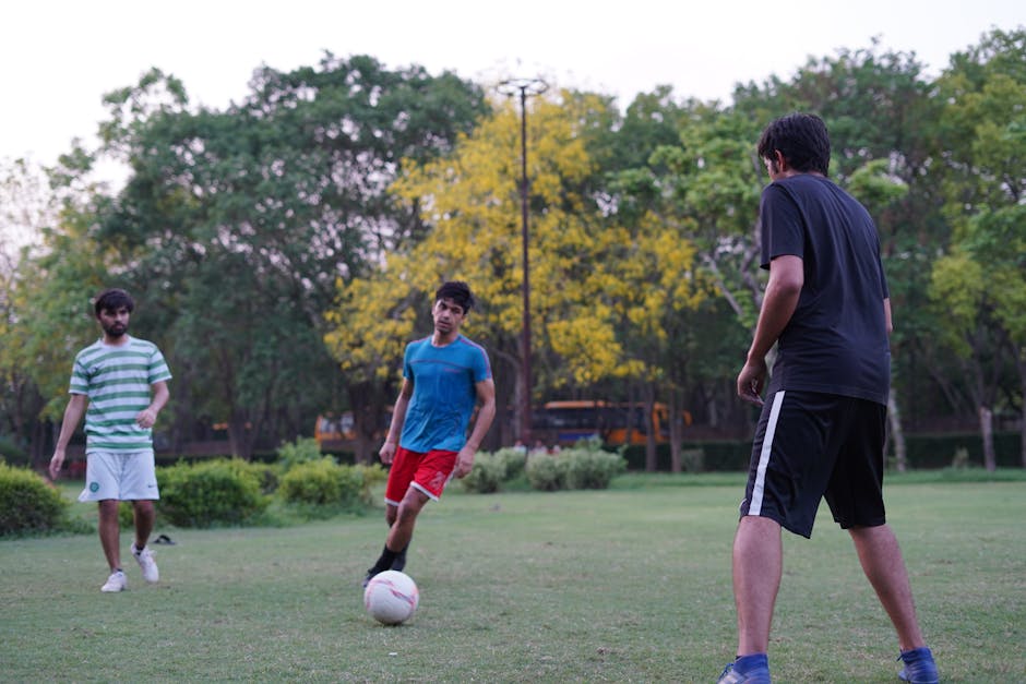 Photo of Men Playing Soccer on Grass Field