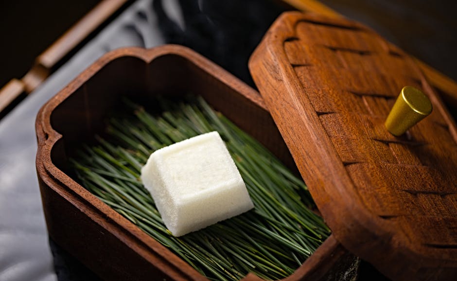 A small square of soap sitting in a wooden box