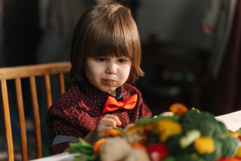 A Cute Little Kid Eating Vegetables