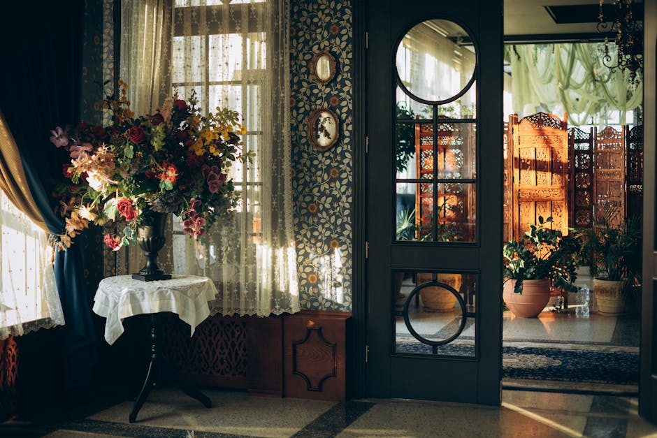 A room with a large window and flowers on the table