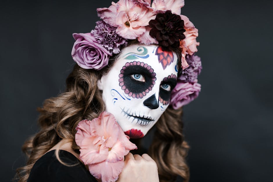 Young female with sugar skull make up and hair decorated with flowers for celebrating Halloween