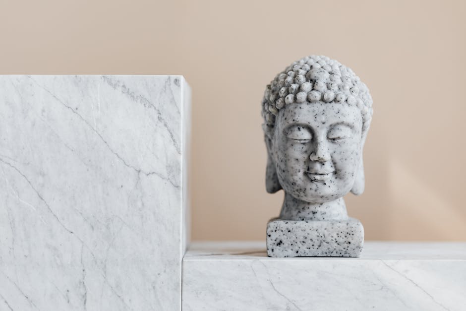 Traditional stone Buddha statue on marble shelf