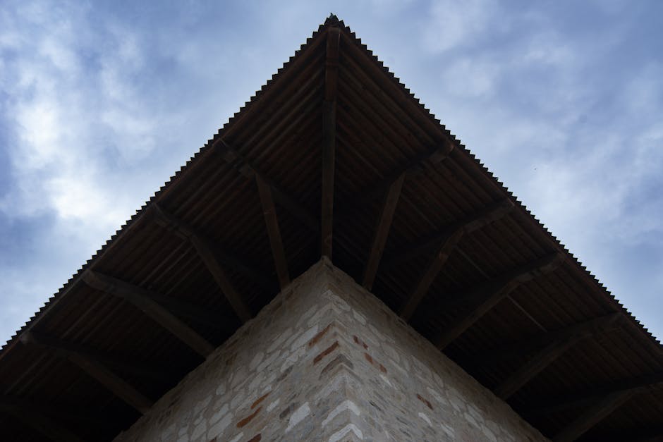 The roof of a building with a blue sky in the background