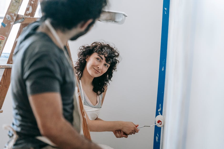 A Couple Painting The House