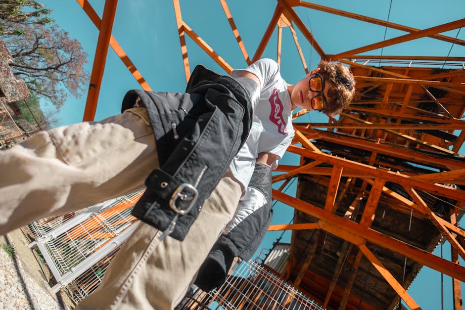 Man Standing in Jacket and T-shirt under Construction Beams