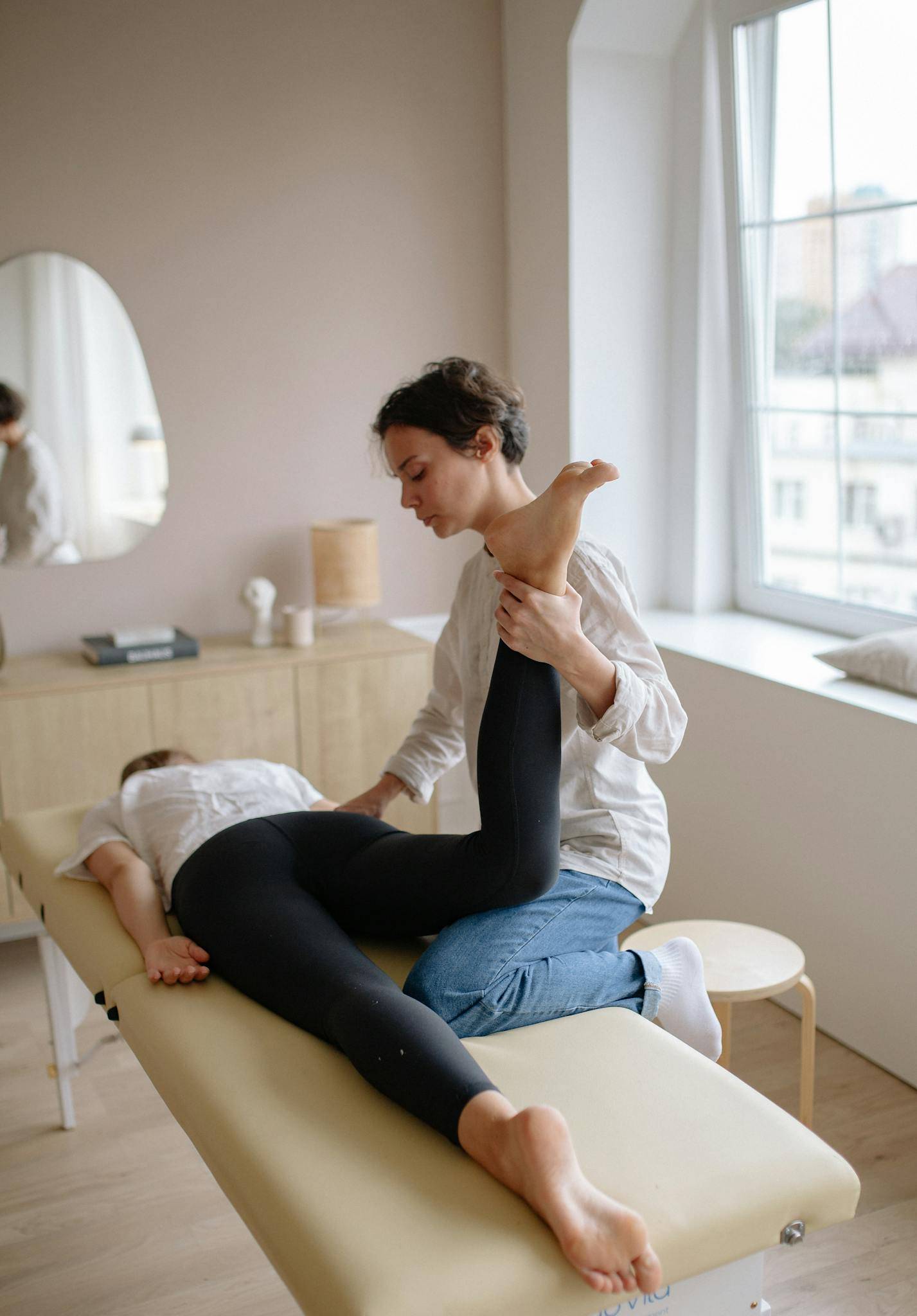 Professional massage therapist treating patient in clinic