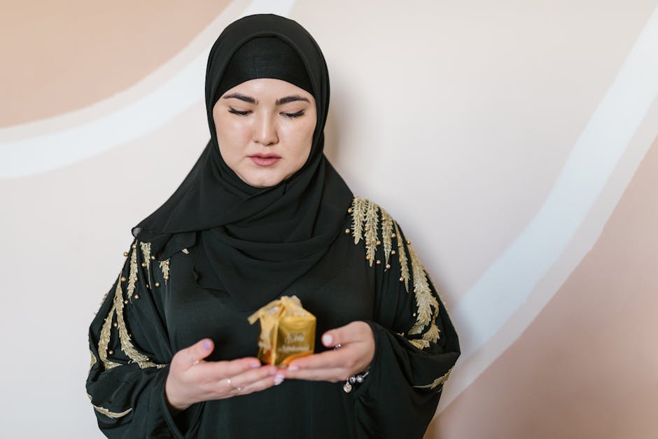 A Woman in Black Hijab Holding a Present