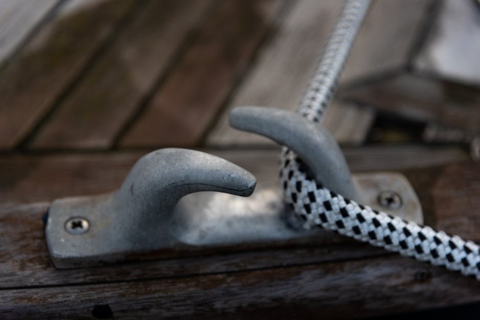 Strong mooring rope on metal hook on shop deck