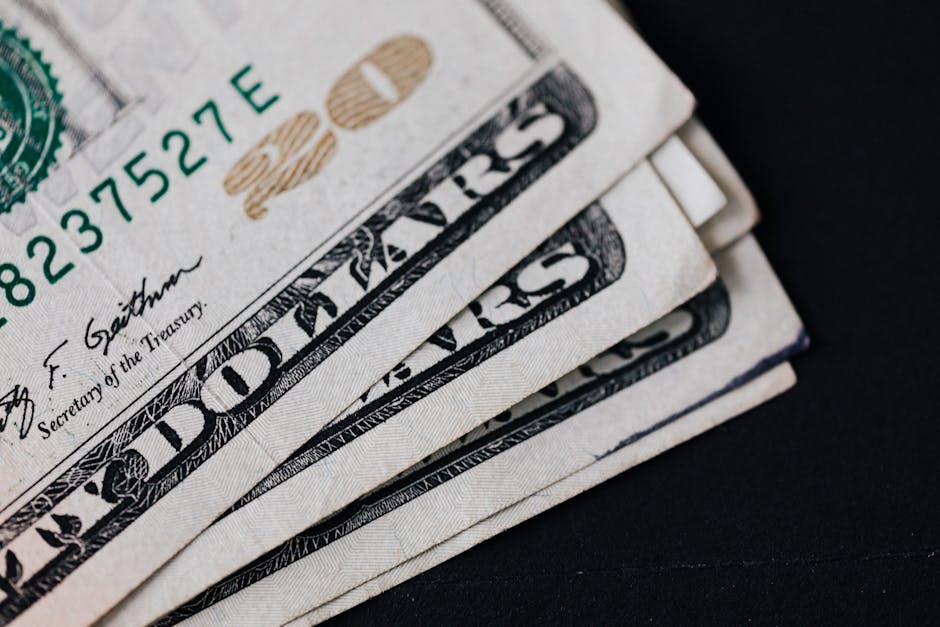 Pile of American paper money on black surface