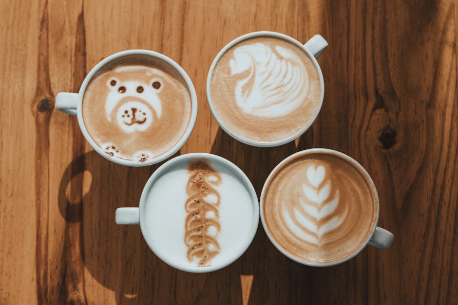 Four coffee cups with different designs on them