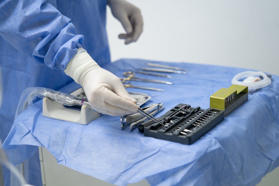 Hands in Rubber Gloves Preparing Surgical Equ