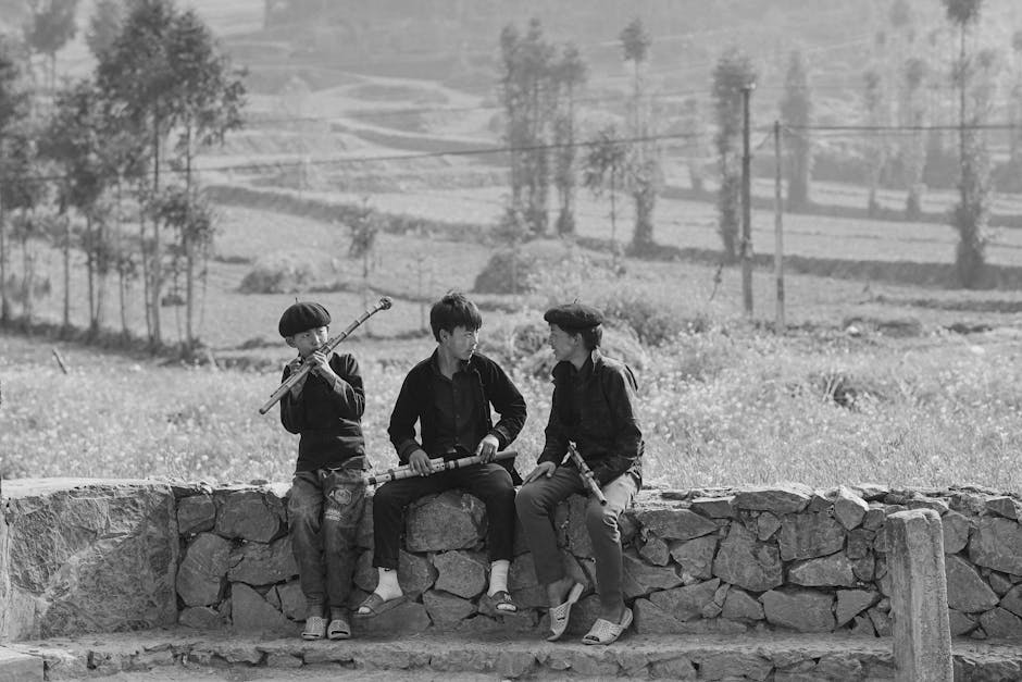 Boys with Musical Instruments Sitting on Fence in Nature