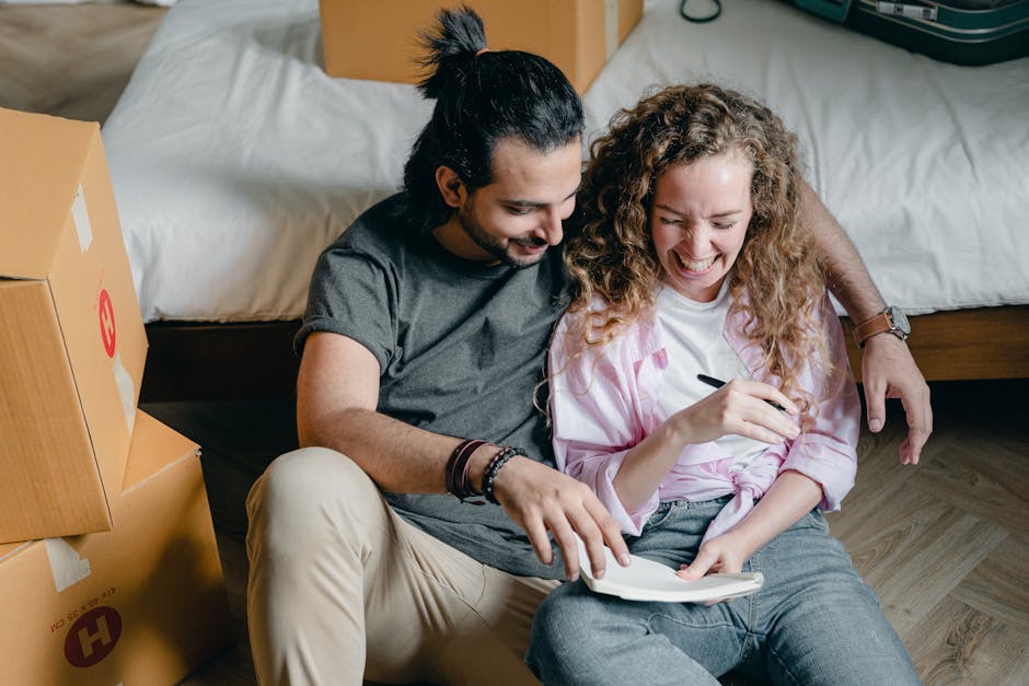 Cheerful couple with notebook moving house