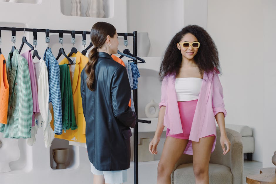 Woman Styling Young Model near Rack with Clothes