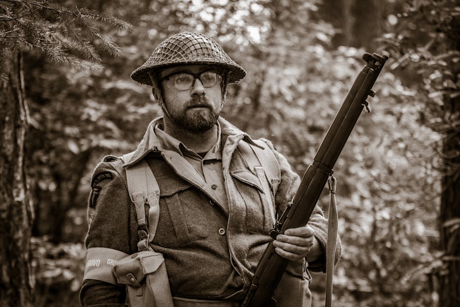 Sepia Toned Photo of a Hunter Holding a Weapon in a Forest