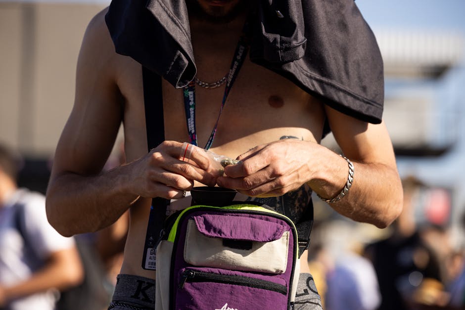 Shirtless Man Holding Bag of Medical Marijuana in Hands
