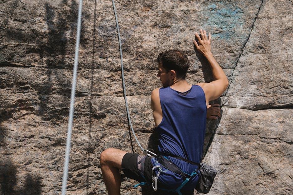 Rock Climber Holding on the Ropes