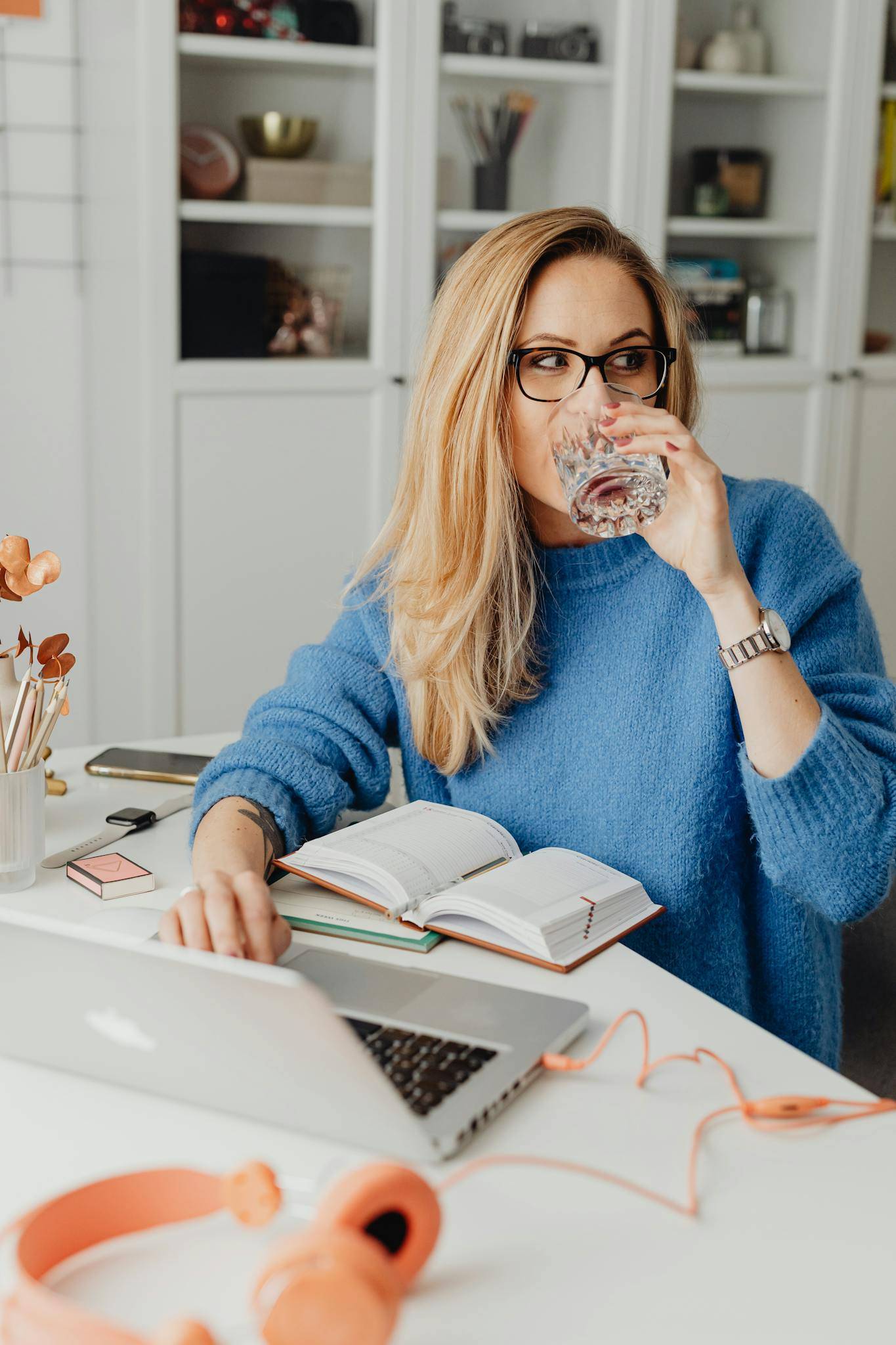 Woman Sitting by the Table Using A Computer Laptop