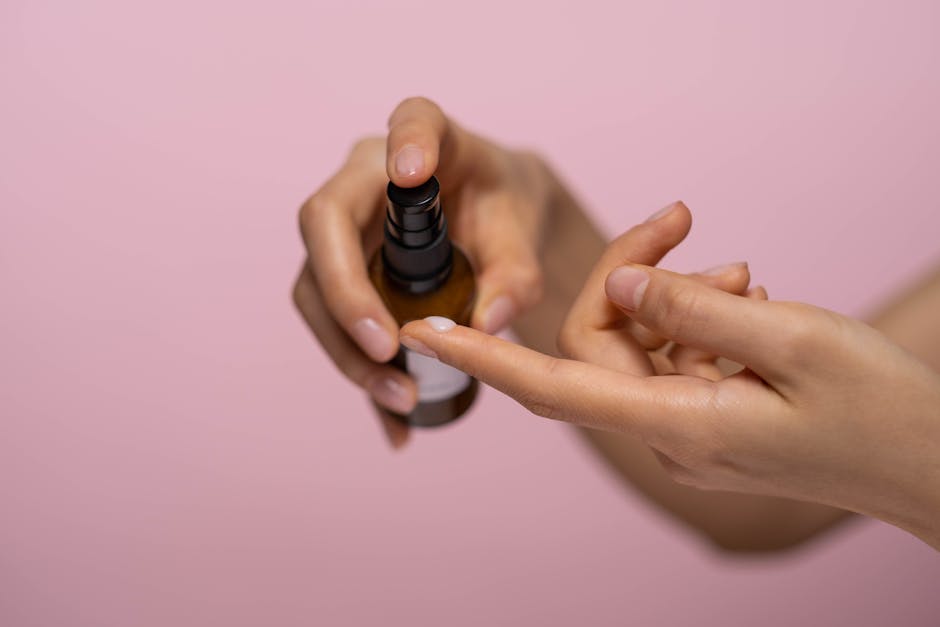 Person Holding Brown Spray Bottle