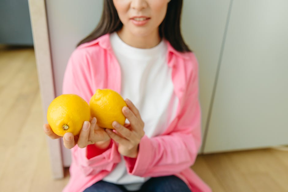 A Woman Holding Yellow Lemons