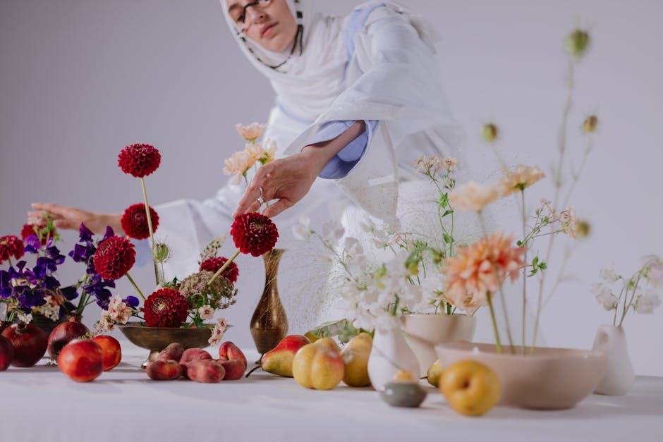 A Woman Arranging Flowers in Vases