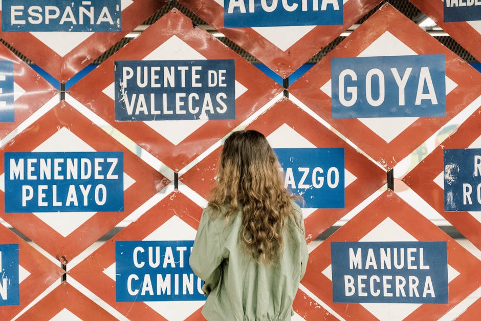 Woman Looking at a Tourism-Themed Billboard in Madrid, Spain