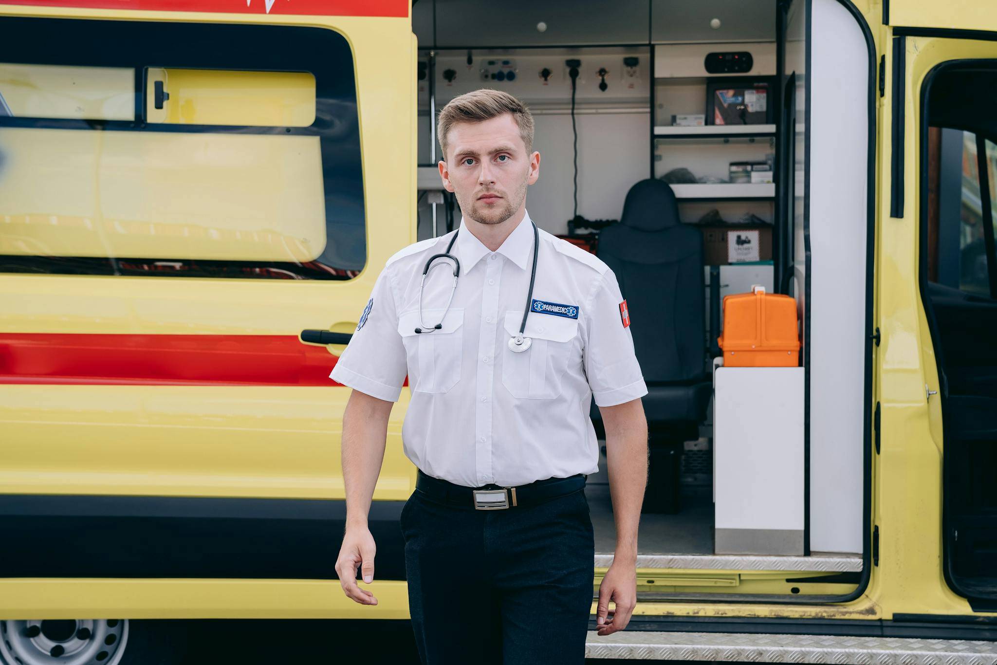 Paramedic Standing Beside an Ambulance