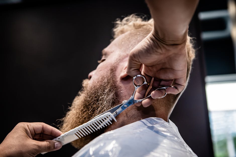 Hands of a Person Trimming a Man’s Beard