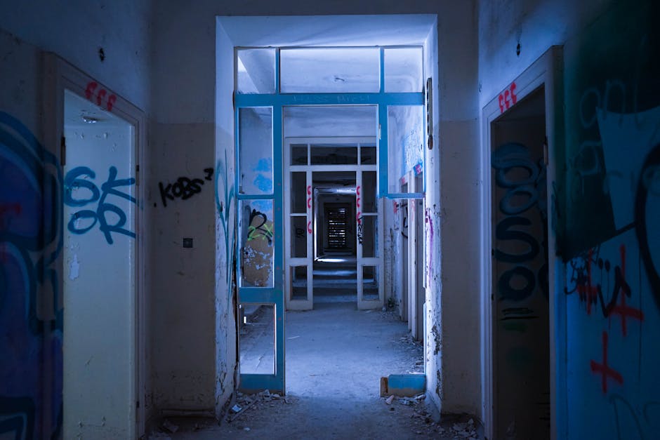 Empty hall in abandoned shabby building with graffiti walls