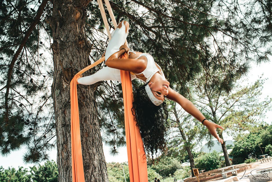 A Woman Aerial Dancing on a Tree