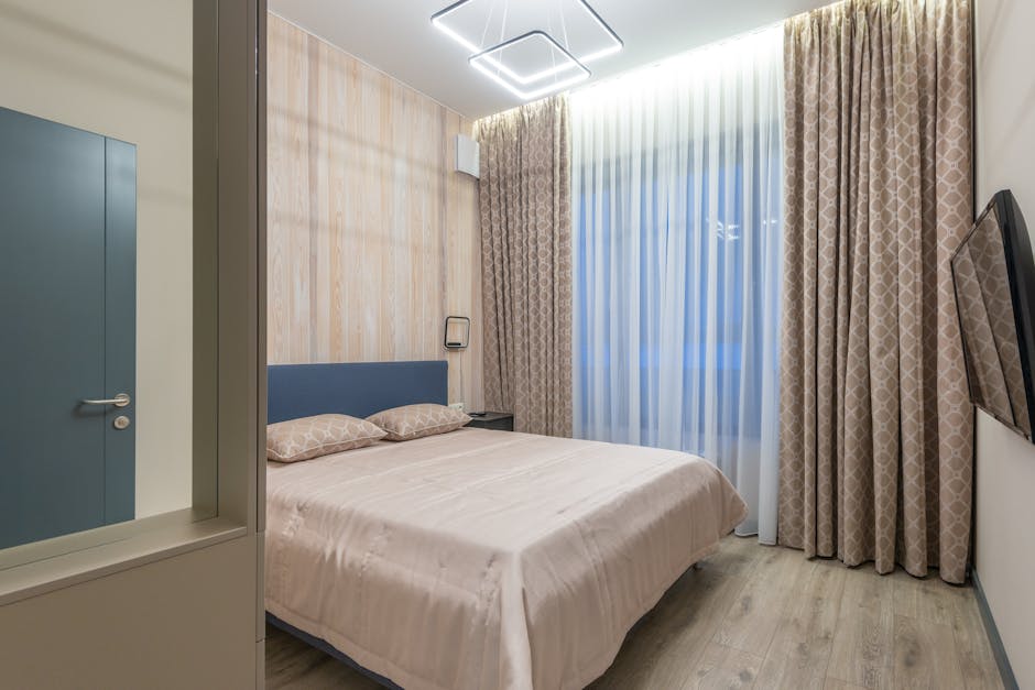 Interior of cozy bedroom decorated with lamps and curtains