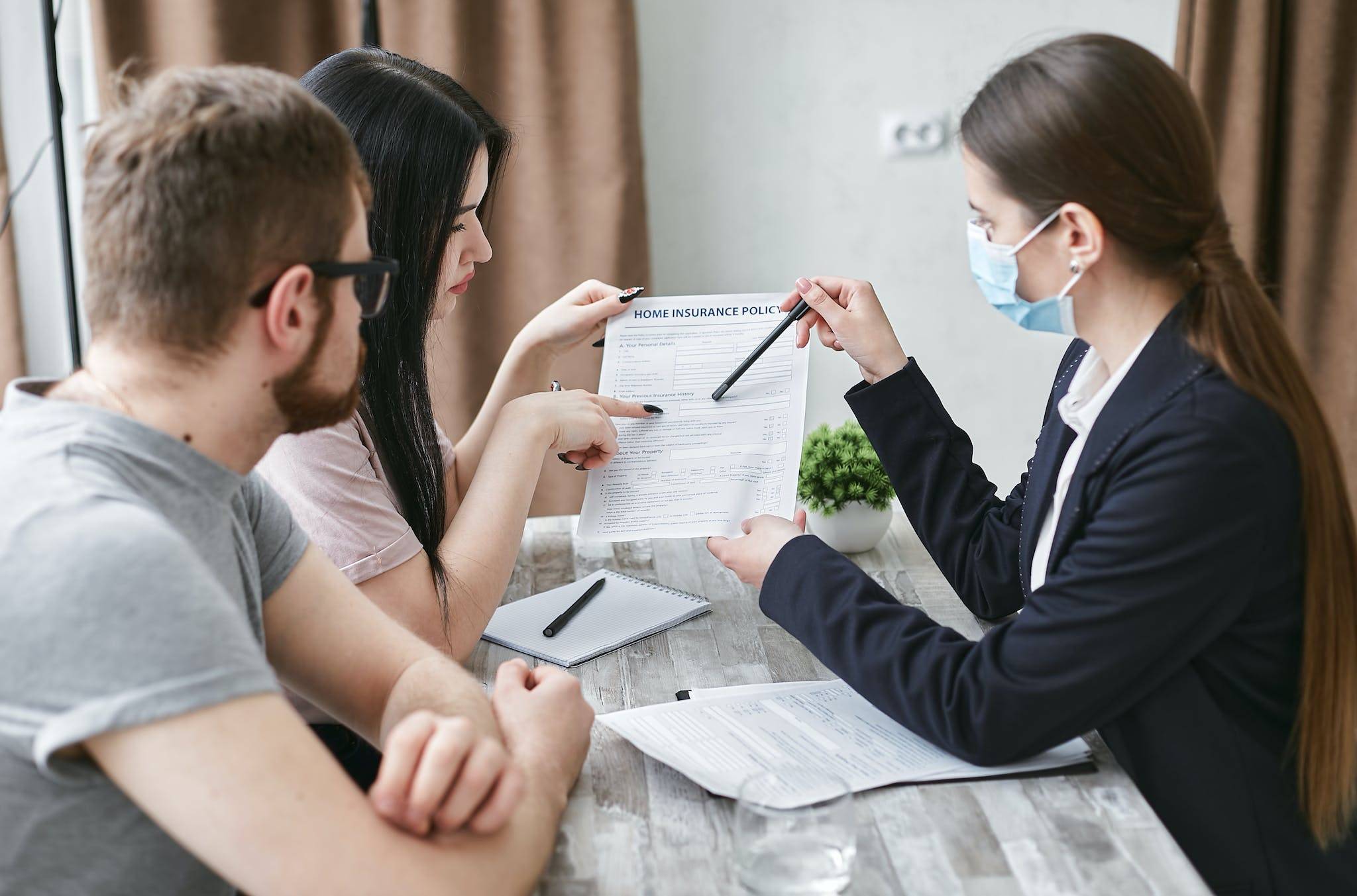 A Woman Explaining a Document to a Couple